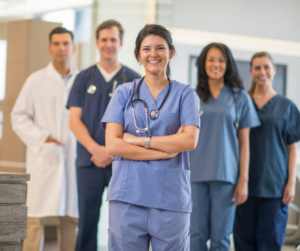 Nurses smiling in line.